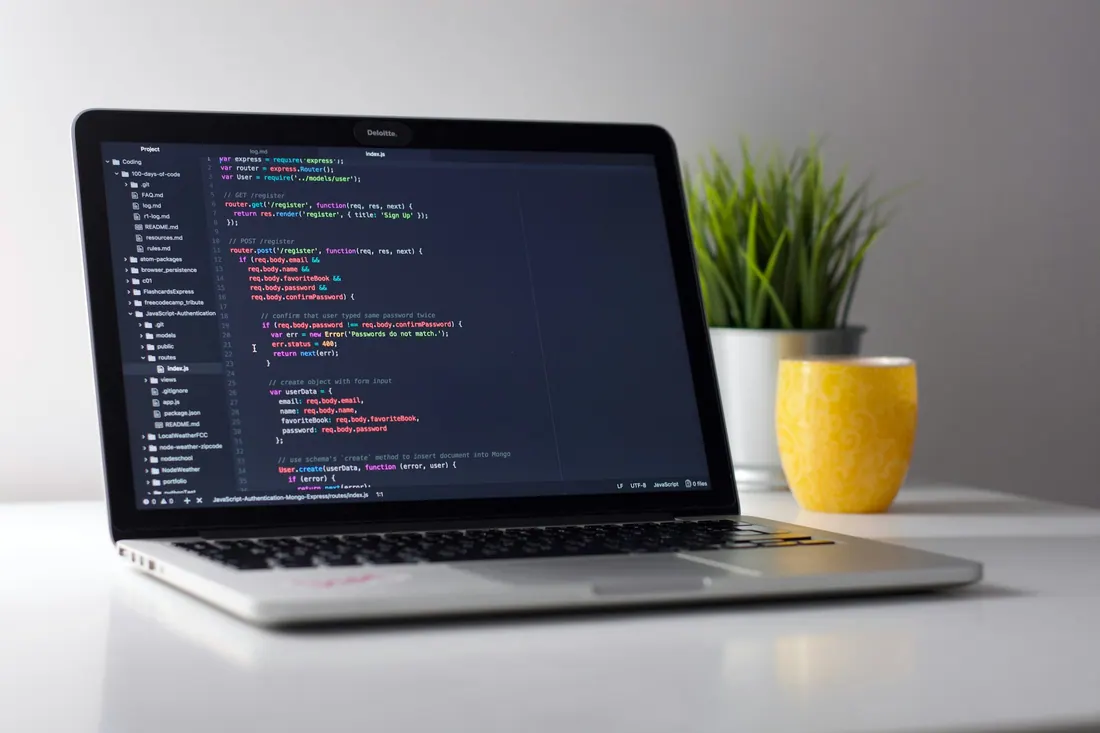 Laptop with code on a clean desk